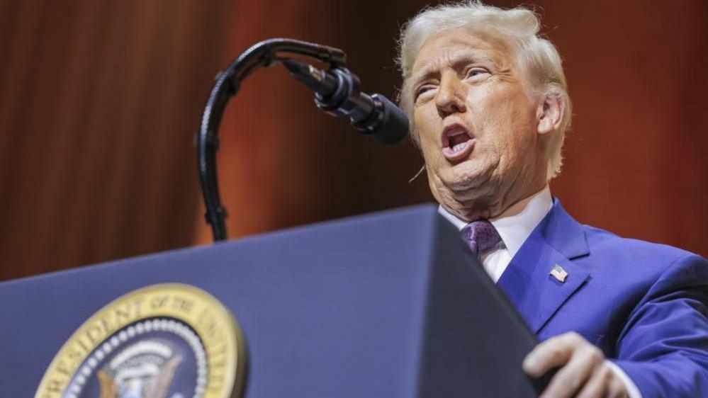 US President Donal Trump Addresses Republican Governors Association Meeting in Washington DC on 20 Feb 2025. He is wearing a blue suit and speaking in front of a microphone