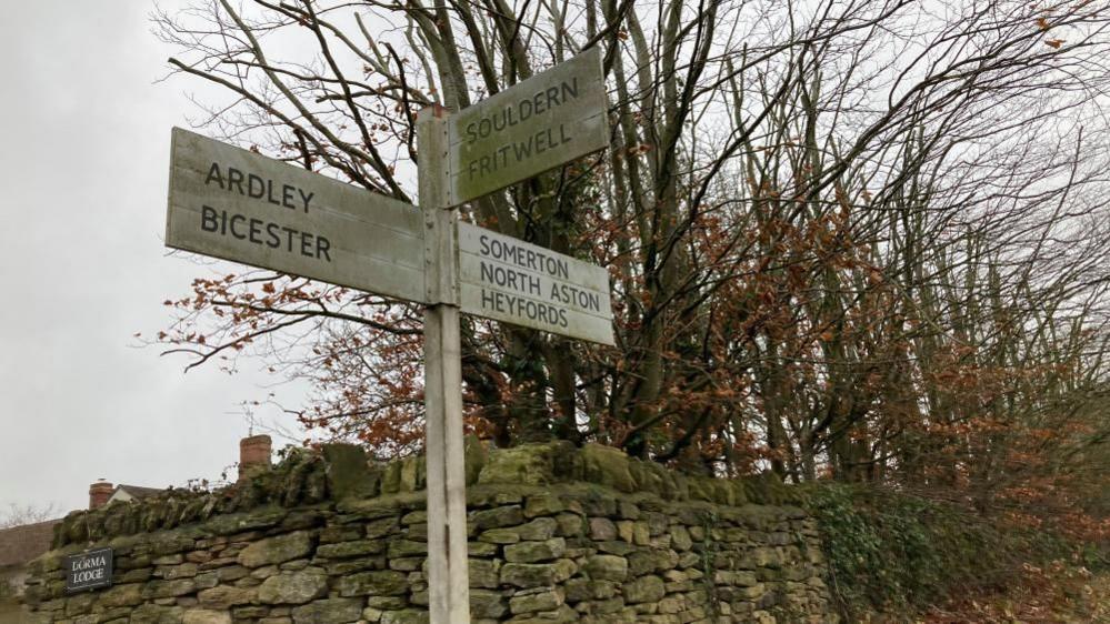 A wooden signpost with the names of Oxfordshire villages