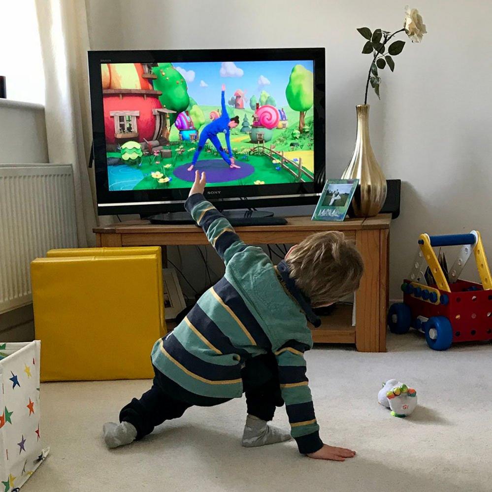 Boy exercising with television