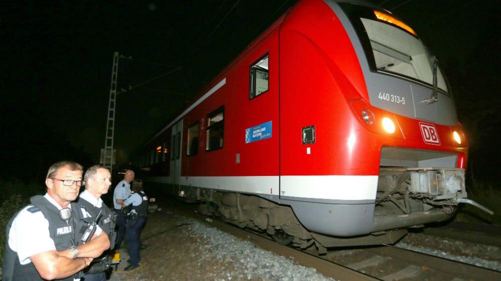 Police stand by regional train on which man wielding axe attacked passengers in Wuerzburg, Germany, 18 July 2016