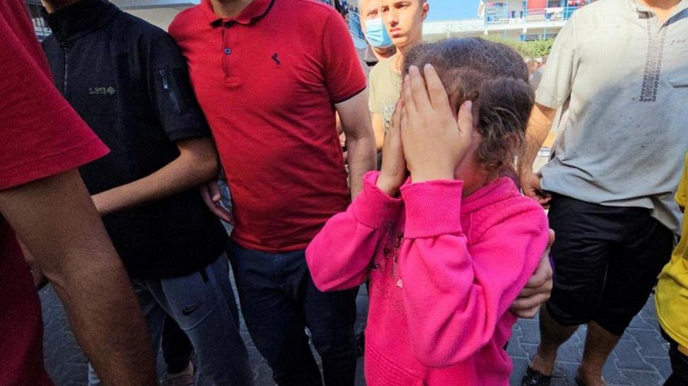 A girl reacts to a hit on a UN school in Gaza