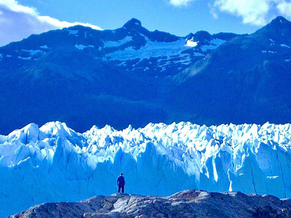 Man looking at a glacier