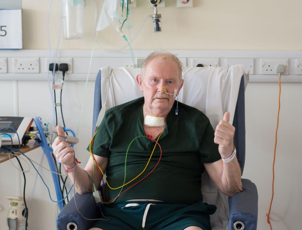 A patients holding his thumbs up