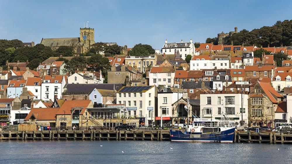 Colourful waterfront houses and a boat pictured in Scarborough in 2016