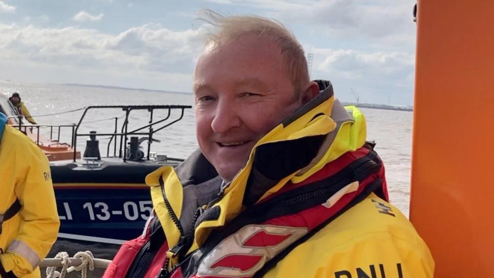 Paddy Lee in his RNLI uniform on board a lifeboat