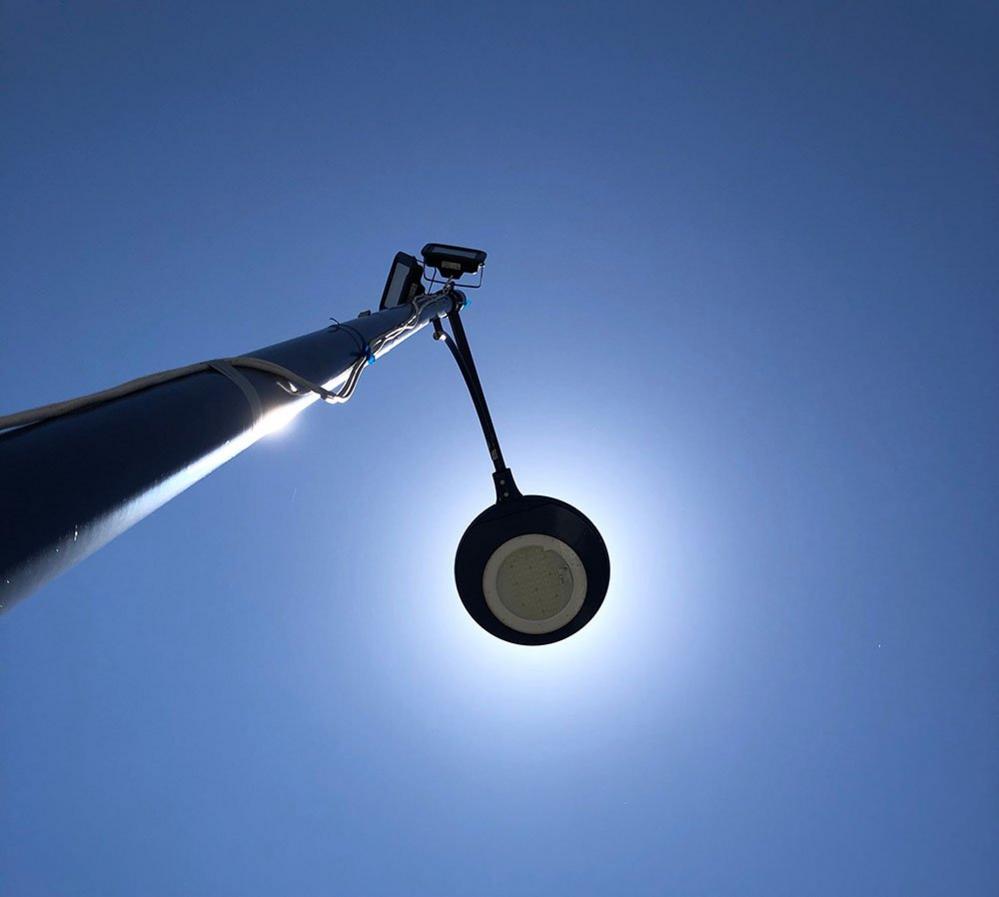 The sun behind a streetlamp