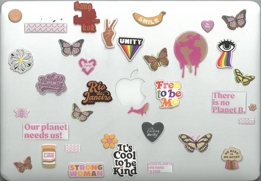 Laptop with many stickers, including environmental issues