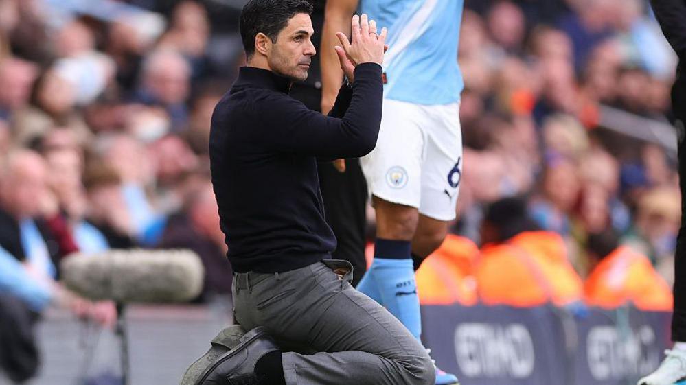 Arsenal manager Mikel Arteta slumps to his knees during the Premier League defeat at Manchester City.