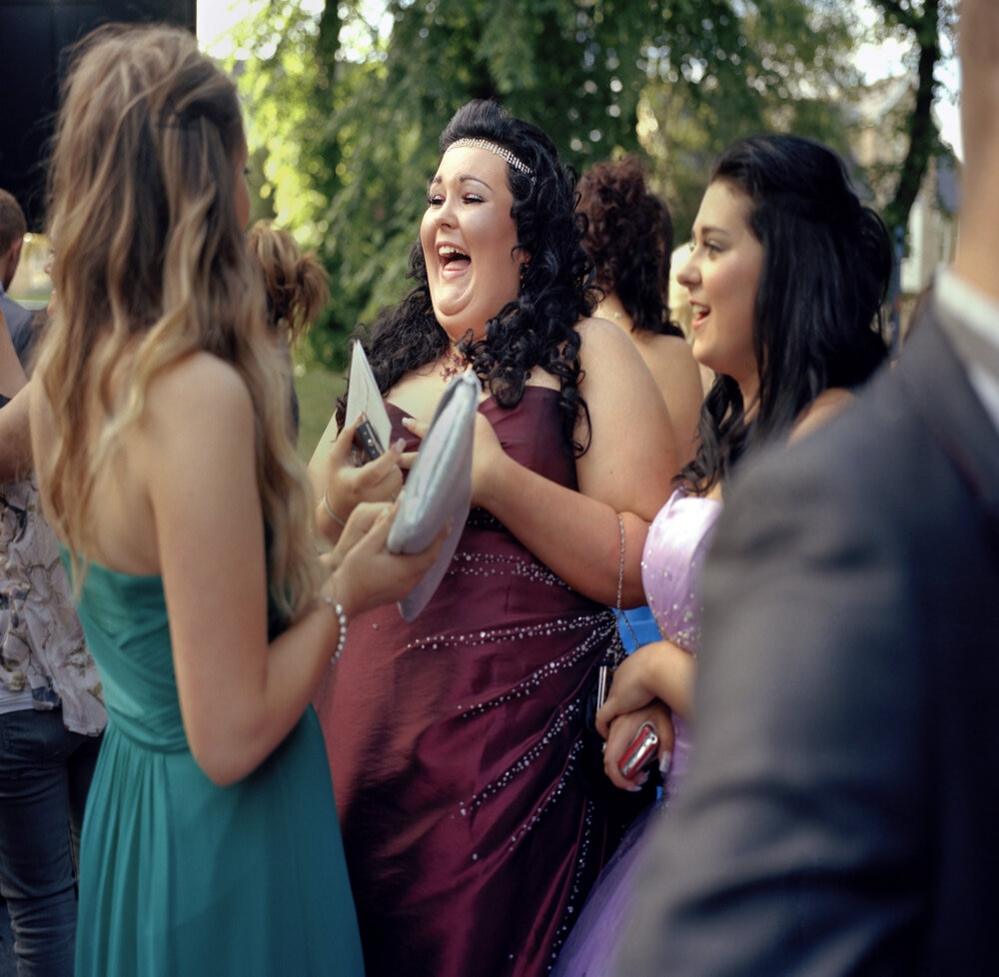 Shannon laughing and joking with friends at her school prom