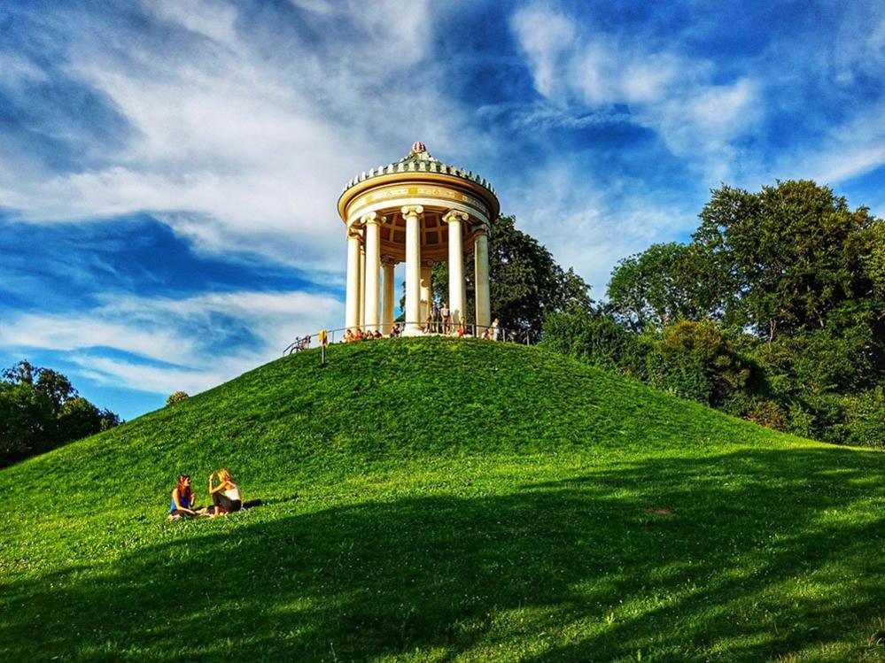 Two people sit on the grass