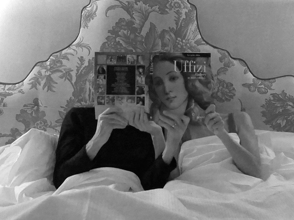 Couple in bed with a book