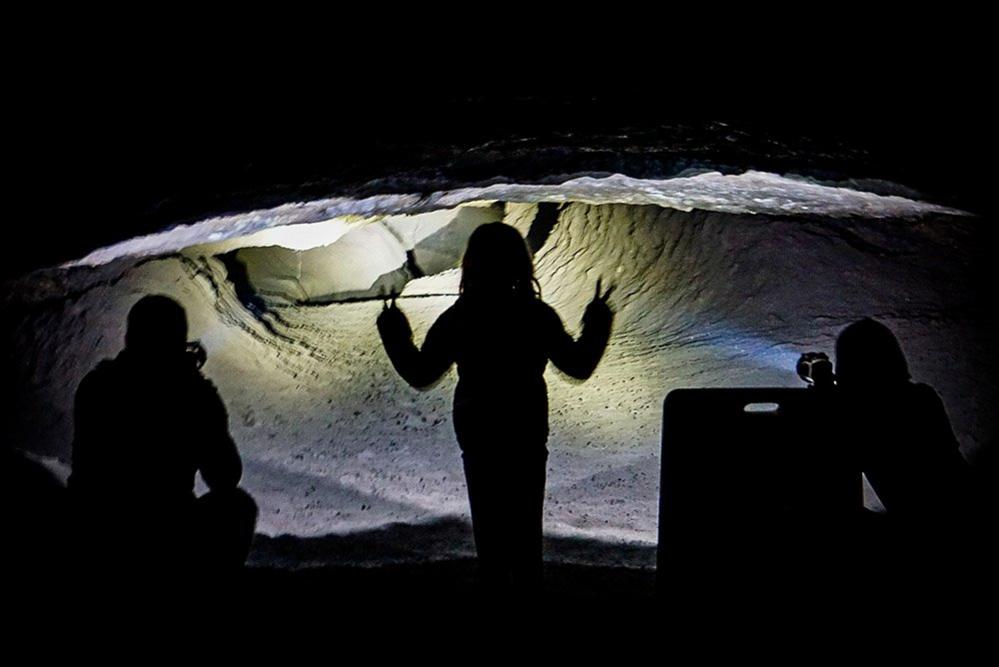 People in a dark cave with torches