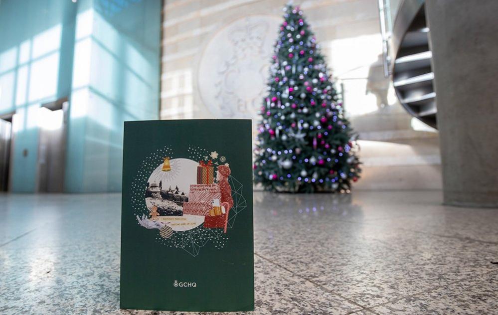 GCHQ Christmas card in front of Christmas tree at GCHQ