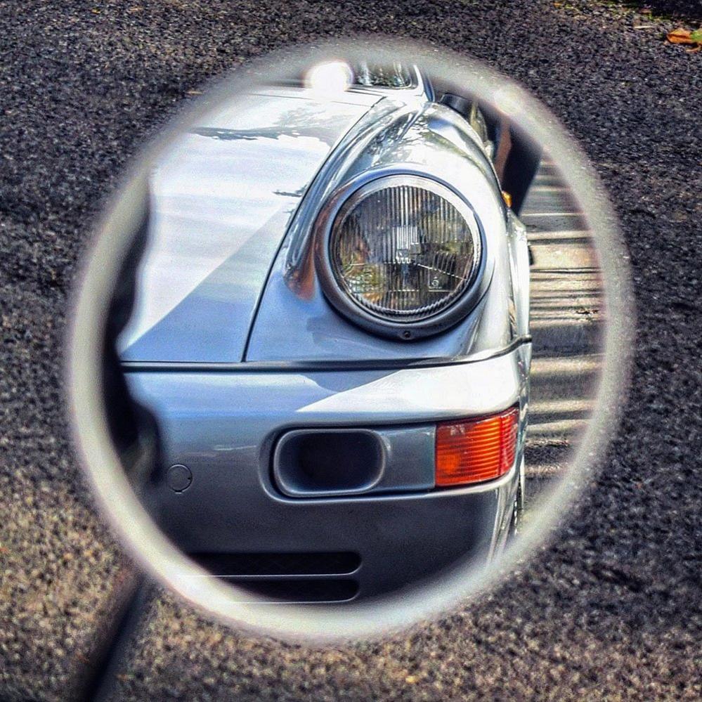 A Porsche car reflected in a mirror