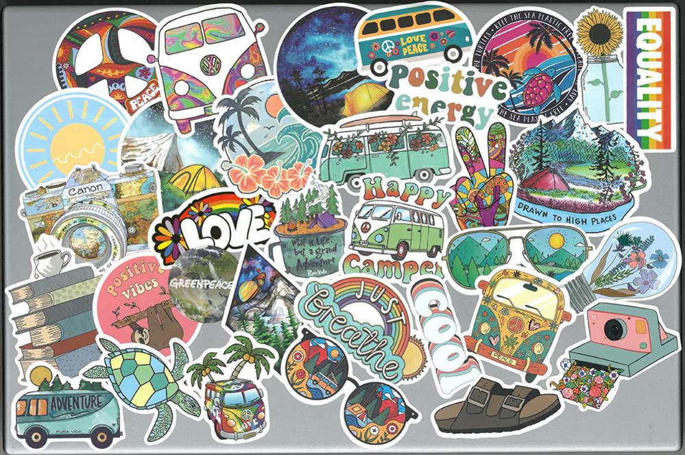 Laptop covered in stickers such as 'love', 'positive energy' and the peace symbol