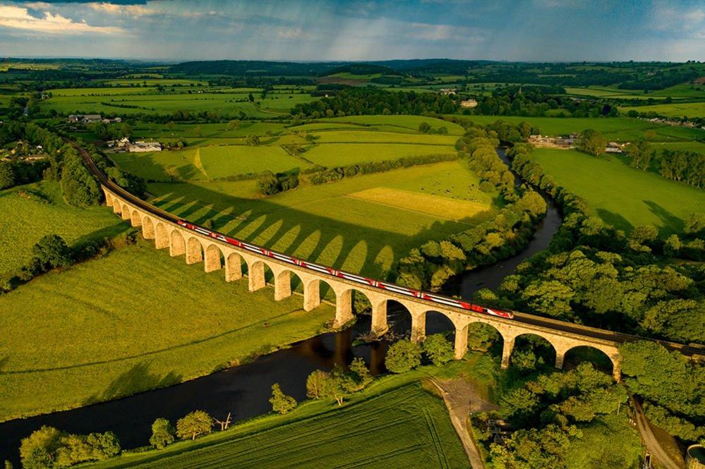 London train crossing the river Wharfe