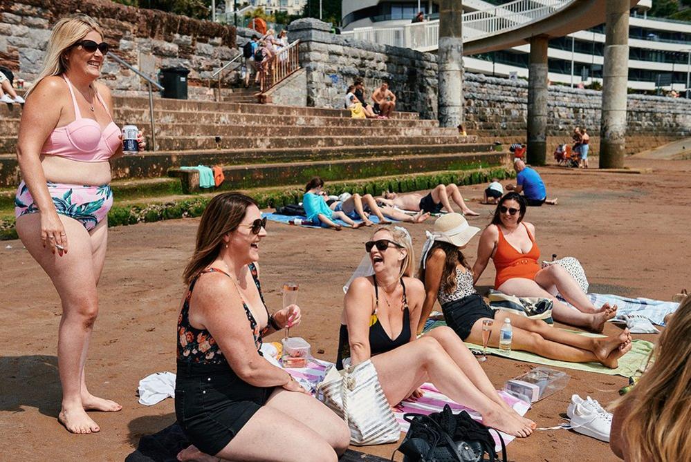 Bride-to-be Suzanne (centre) laughs with her bridesmaids and friends on her hen weekend in Torquay