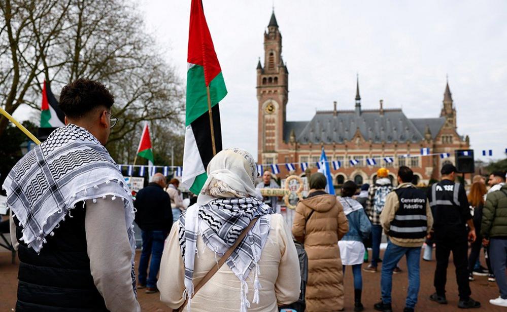 Demonstrators with Palestinian and Nicaraguan flags gather outside the International Court of Justice (ICJ) in The Hague on 8 April