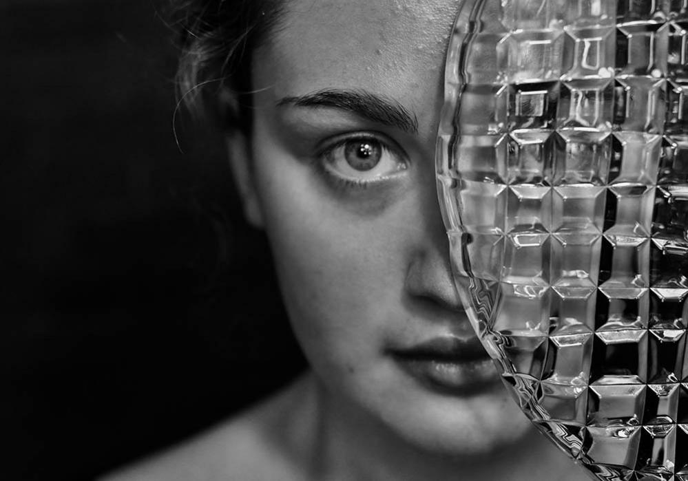 Woman with a plate covering half of her face