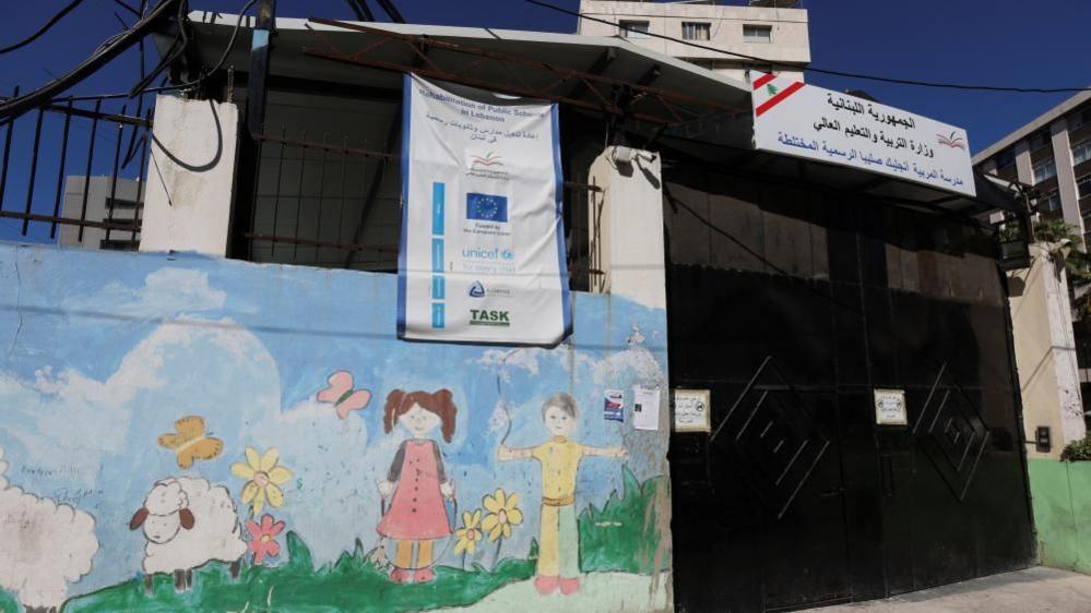 A view shows a closed gate of a school, following pager detonations across Lebanon on Tuesday, in Sidon, Lebanon