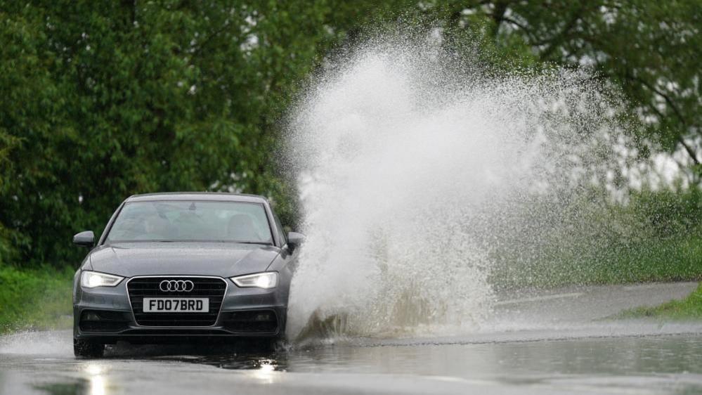 Car driving through puddle