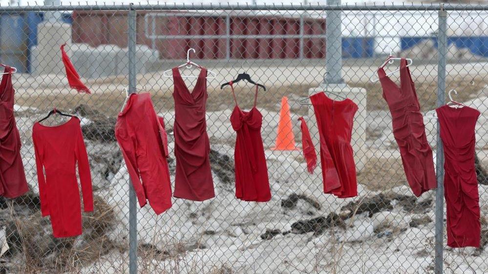 Red dresses, hung in honour of missing and murdered Indigenous women, girls and two-spirit individuals, line fences at Brady Road Resource Management Facility, where the body of 33-year-old Linda Mary Beardy of Lake St. Martin First Nation was discovered, in Winnipeg, Manitoba, Canada, April 4, 2023