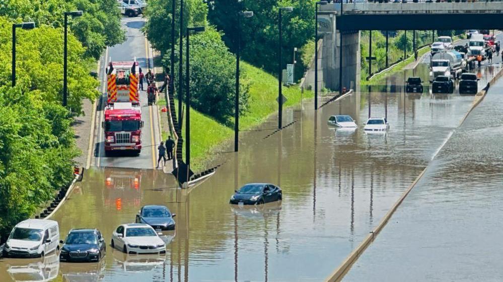 A cyclist views a flooded section of the Don Valley Parkway after heavy rains hit Toronto, Ontario, Canada July 16, 2024.