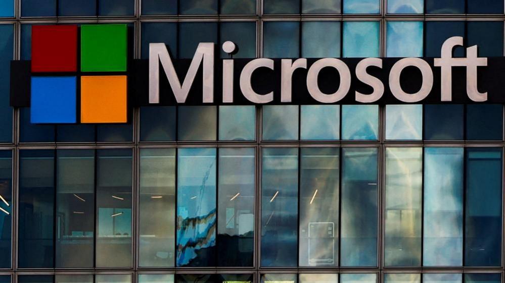The Microsoft logo is lit up on a glass building in Paris