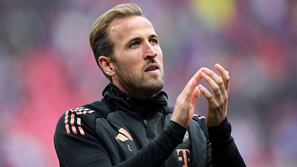 Harry Kane applauds supporters after the match