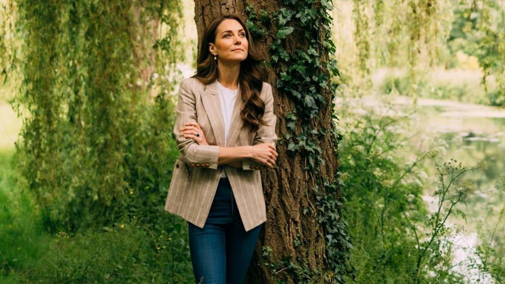 Princess of Wales standing by a tree