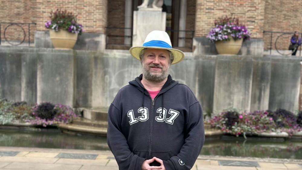 A man standing in front of Bristol's City Hall