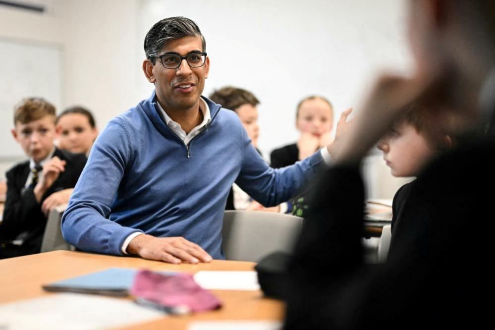 Rishi Sunak meets with students in a class during a visit to a school