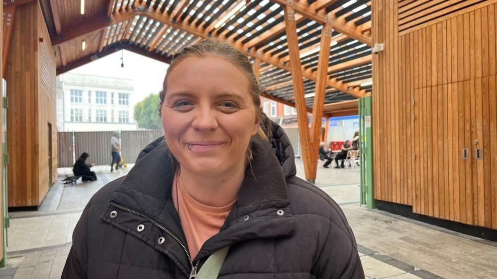 Charlie Brown, 32 of Great Yarmouth, standing in Great Yarmouth Market Place and smiling at the camera