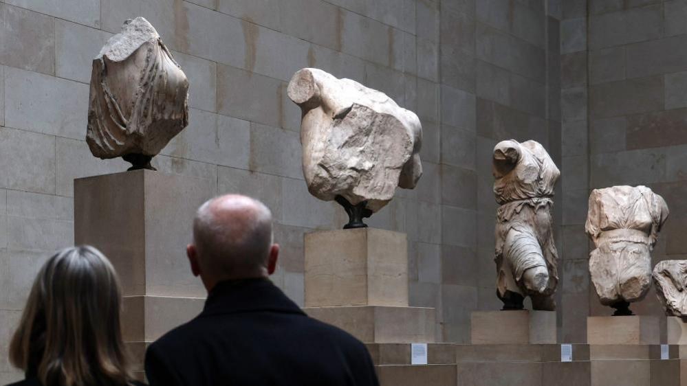 A couple view the Parthenon Sculptures, also known as the Elgin Marbles, at the British Museum.