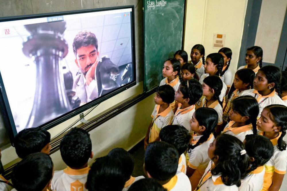 Students watch a live telecast of India's Gukesh Dommaraju competing against China's Ding Liren during the FIDE World Chess Championship Singapore 2024, at a school in Chennai on November 25, 2024