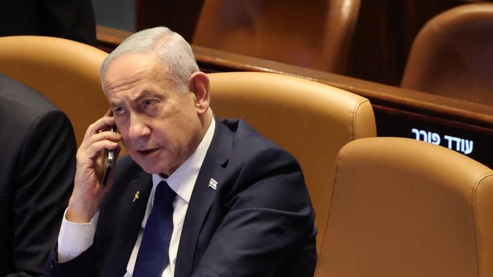 Israeli Prime Minister Benjamin Netanyahu speaks on the phone