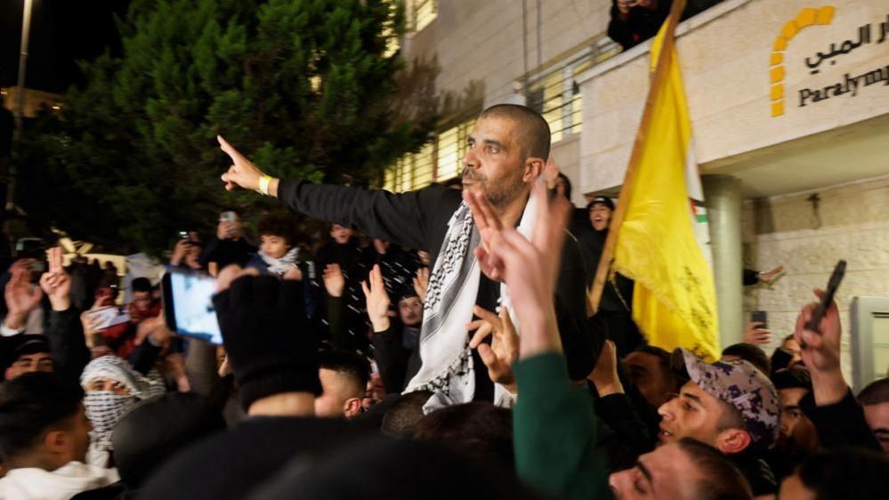 Zakaria Zubeidi who was convicted for his involvement in the deaths of several Israelis carried aloft in Ramallah