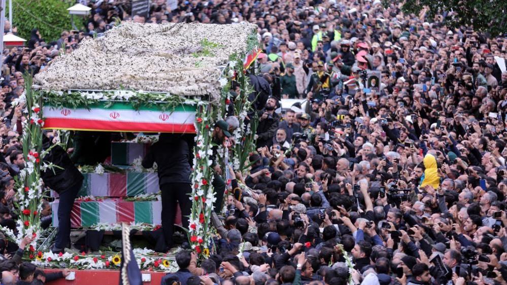 Iranian mourners pay their respects to late president Ebrahim Raisi and his aides during a funeral procession in Tabriz, northwestern Iran