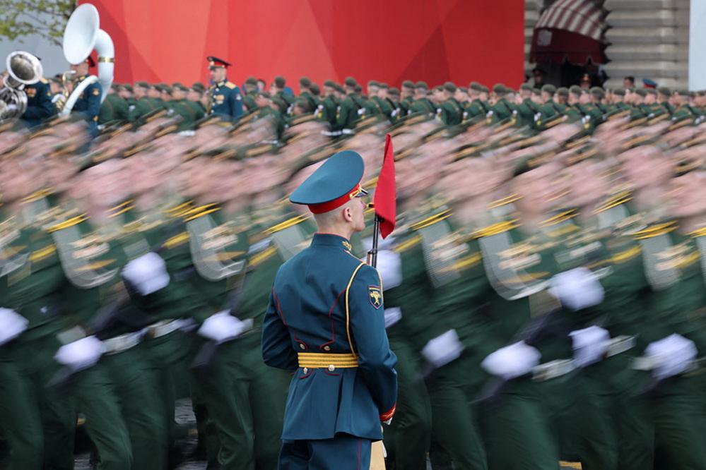 Russian service members march past an honour guard in Red Square in central Moscow, Russia