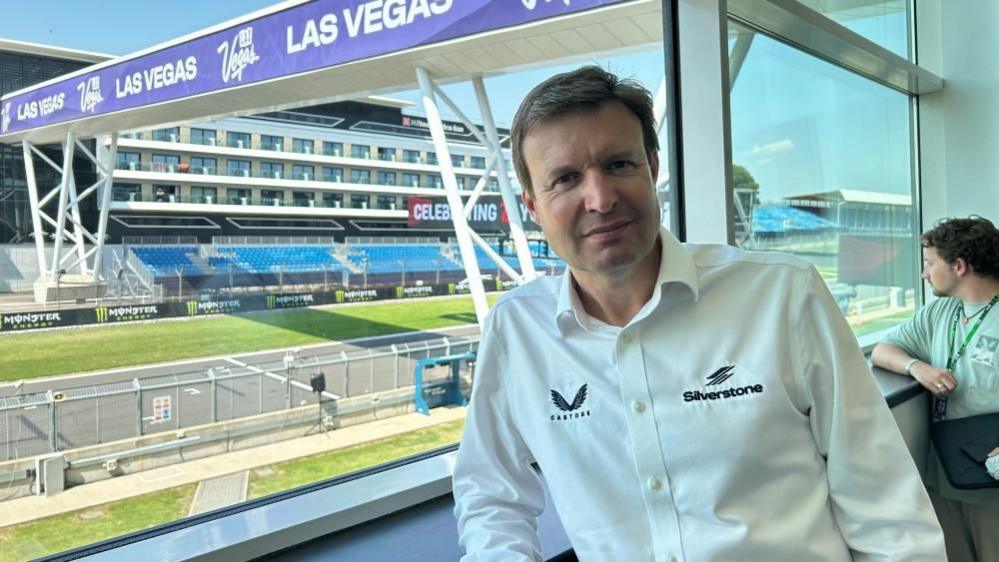 Stuart Pringle with short fair hair wearing a Silverstone shirt overlooking the circuit