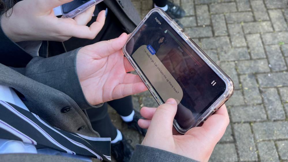 Child's hands operating a mobile phone