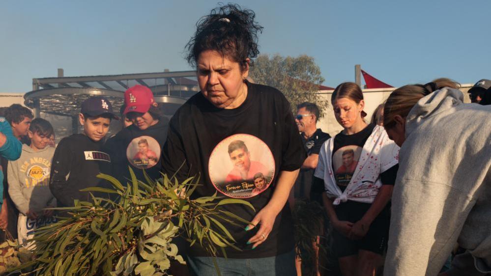 Mechelle Turvey, the mother of Cassius Turvey, takes part in a smoking ceremony during a vigil for her son Cassius Turvey