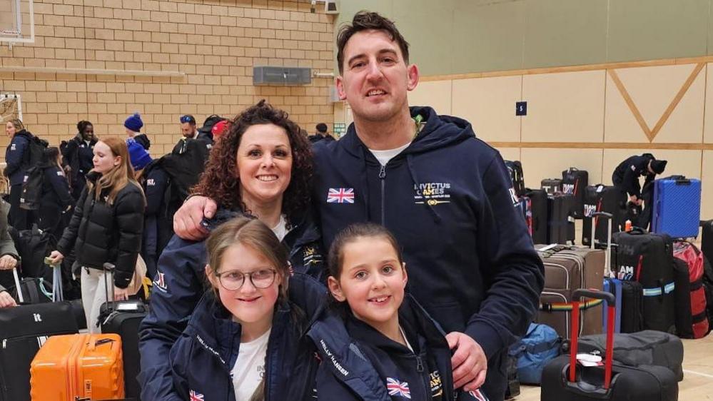 Wife Claire with Ben and their two daughters in Vancouver. They are all wearing Invictus Games jackets.