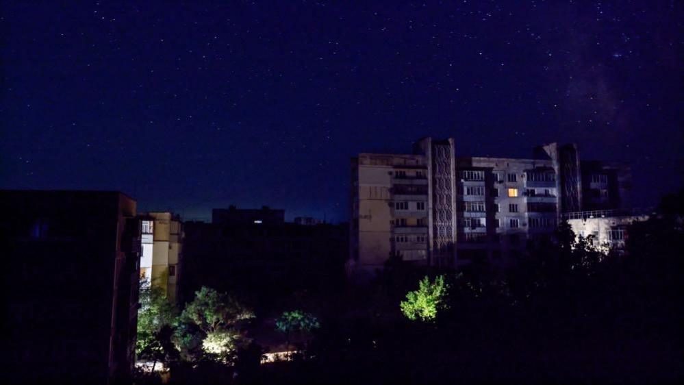 Residential buildings at night during a temporary power outage, which local authorities said was caused by technological disturbances in the peninsula’s energy grid