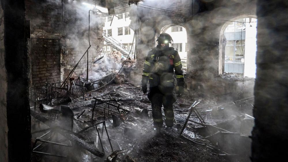 Ukrainian rescuers work at the site of a Russian strike on a kindergarten in Kharkiv, northeastern Ukraine, 22 October 2025