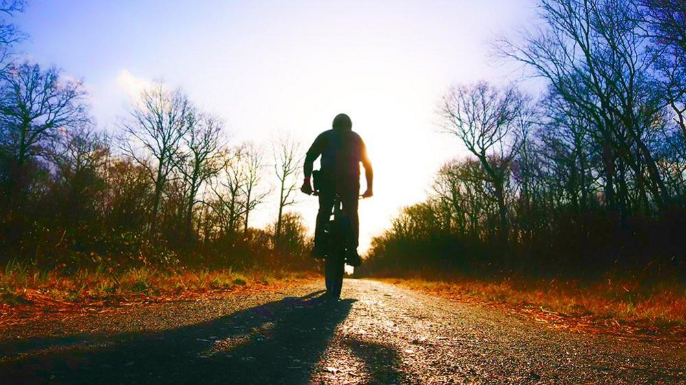 Cyclist heading into the distance