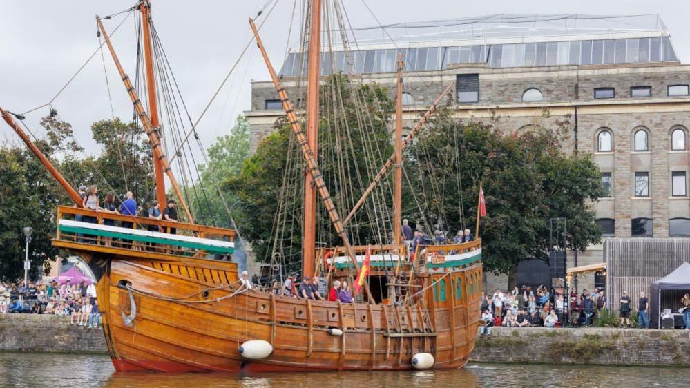 An historic ship in Bristol's harbour as crowds gather for Harbour Festival 2024.