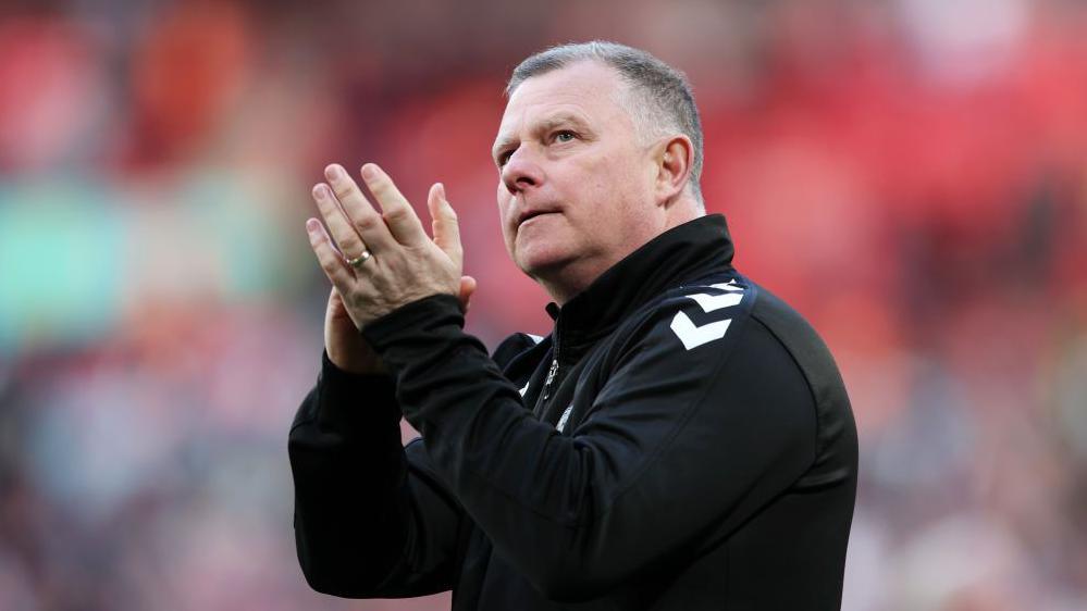 Mark Robins claps the Coventry fans