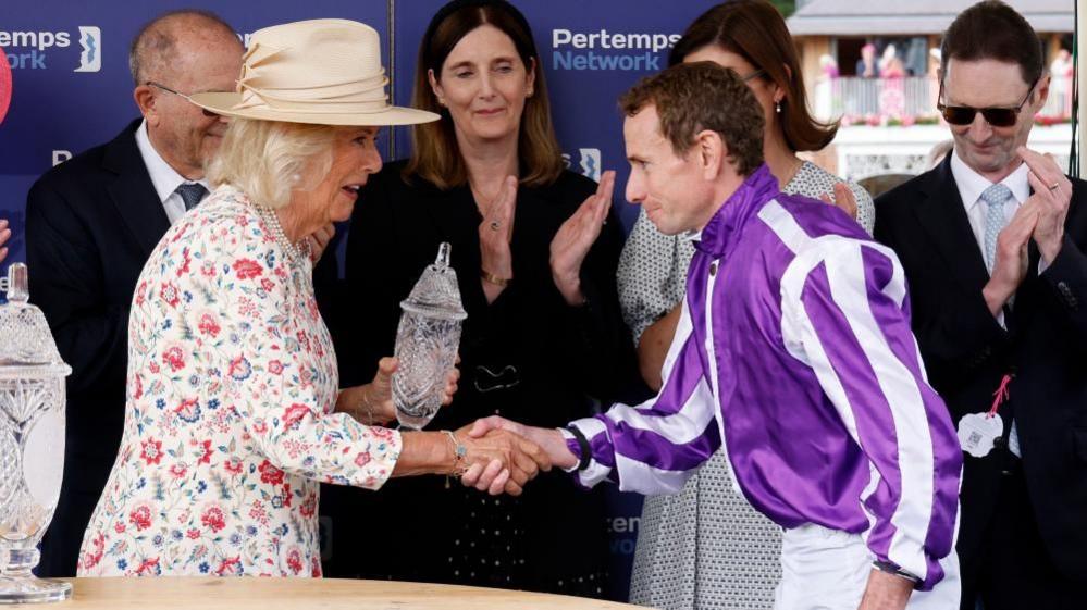 The Queen presents the Yorkshire Oaks trophy to jockey Ryan Moore.