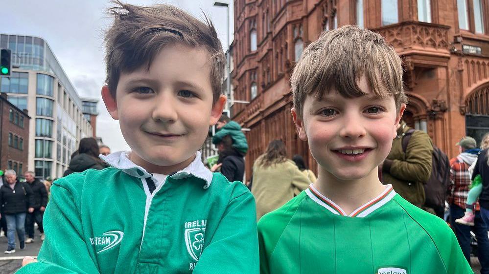 Two boys in green shirts